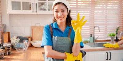 Residential cleaning team preparing a spotless kitchen with professional maid service.